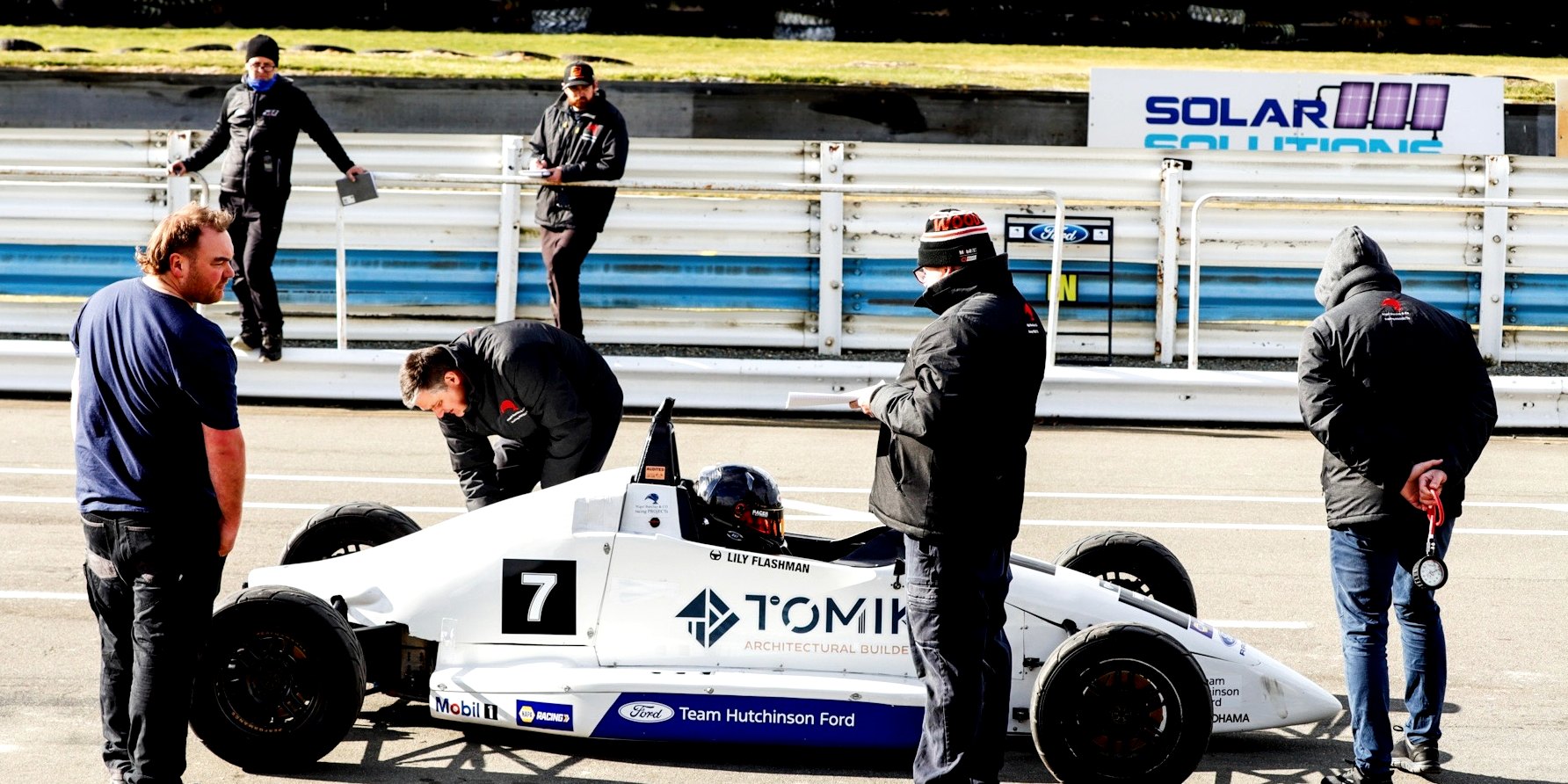 The whole team around the car on the dummy grid